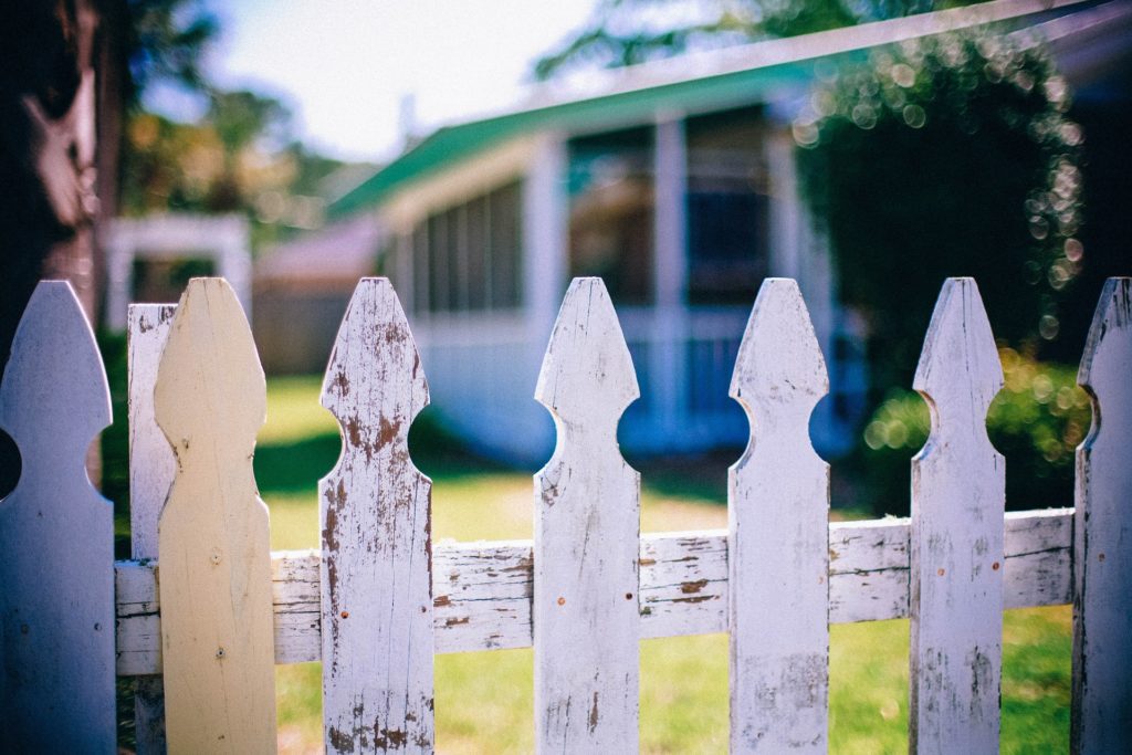 white picket fence dividing neighbours