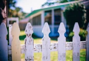 white picket fence dividing neighbours