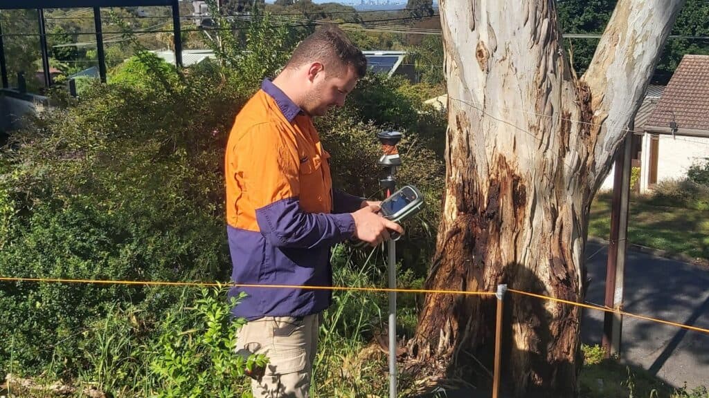 alexander symonds surveyor using mobile device on site